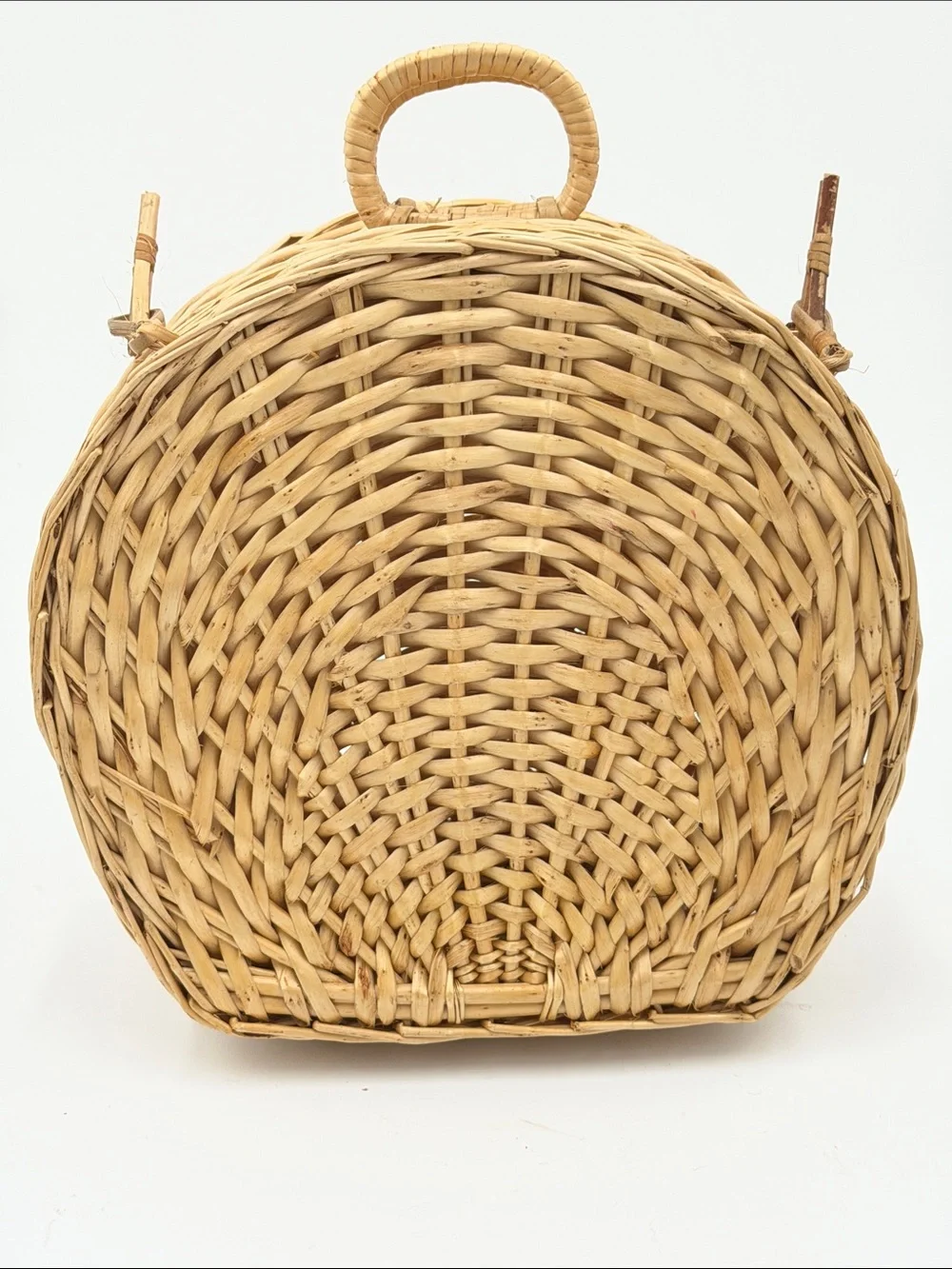 A Cute, charming vintage shell-shaped rattan storage basket with a front handle.